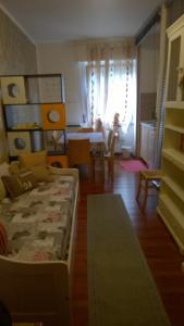 a living room with a bed and a dining room at La Casa della Musica in Gorizia +14 photos