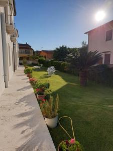 a garden with potted plants on the side of a house at Villa Alberta Hotel in Pula