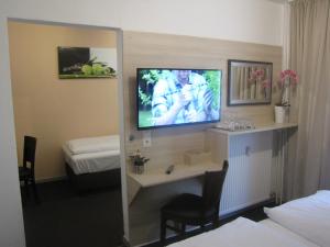 a hotel room with a television on the wall at Milano Hotel in Hamburg