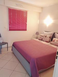 a bedroom with a large bed and a window at La terrazza di monaco in Cap d'Ail