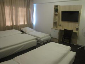 Postel nebo postele na pokoji v ubytování Milano Hotel