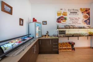 a fast food restaurant with a counter with food at Hostal Casa Mercedes in Nerja