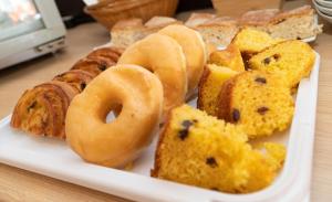 a plate of donuts and pastries on a table at Hostal Casa Mercedes in Nerja