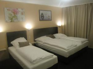 Ένα ή περισσότερα κρεβάτια σε δωμάτιο στο Milano Hotel