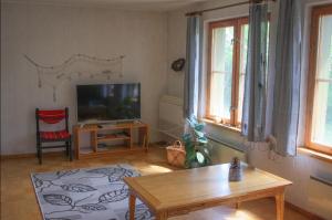 a living room with a television and a coffee table at Paadi puhkemaja in Salinõmme