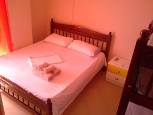 a bedroom with a bed with a stuffed animal on it at Nada SeaView Apartment in Shëngjin