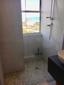 a bathroom with a shower and a sink and a window at Grattacielo Royal Palace in Milano Marittima