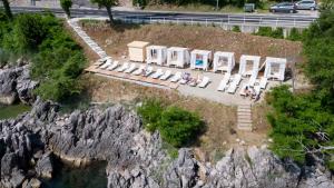 an aerial view of a group of tables and chairs on a mountain at Boutique Hotel Acacia in Lovran