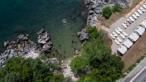 an aerial view of a beach with rocks and water at Boutique Hotel Acacia in Lovran
