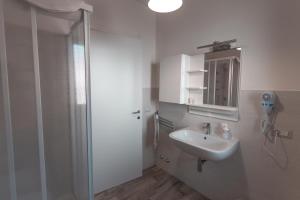 a bathroom with a sink and a shower with a mirror at Apartment Bolsena Casa Vacanze in Bolsena +32 photos