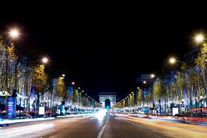 a street lined with trees with lights at night at Loft atelier d'artiste Cœur de Paris. Exceptionnel ! in Paris