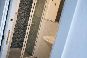 a bathroom with a glass shower with a sink at Renato Canalone in Ponza