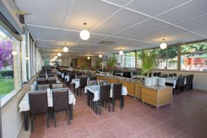 a dining room with tables and chairs in a restaurant at The One Club Hotel in Sarigerme