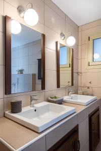 a bathroom with two sinks and a large mirror at Aegean sea view luxury residence Thassos in Prinos