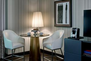 a table with two chairs and a lamp in a room at Sofitel Philadelphia at Rittenhouse Square in Philadelphia