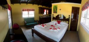 a bedroom with a bed with red flowers on it at Inn at White Horse Guest House in Hopkins