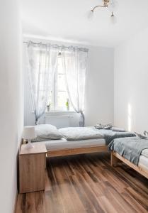 a bedroom with two beds and a window at Apartament na Wyspie Piasek in Kłodzko