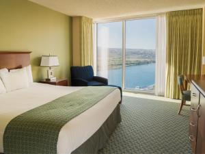 A bed or beds in a room at Aquarius Casino Resort