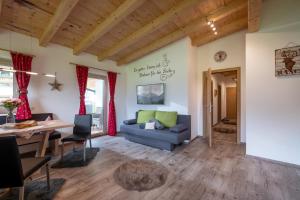 a living room with a table and a couch at Alpinjuwel in Hippach in Hippach