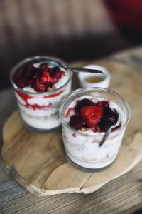 two dishes of food with berries in them on a table at Penzion U Kubesa - Adults only in Kroměříž