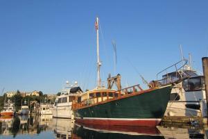 a green boat is docked in a harbor at Wharfside Bed & Breakfast in Friday Harbor