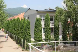 a man walking down a sidewalk in front of a building at Apartman KEJ in Pirot