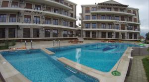 a large swimming pool in front of a building at Perla di boka in Baošići