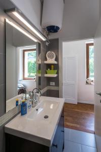 a bathroom with a sink and a mirror at La Casa di Davide - David Home in Cave del Predil