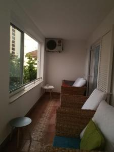 a living room with two couches and a window at D&M APARTMAN 2 in Selce