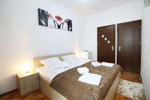 a bedroom with a large bed with two towels on it at Anne's House in Sibiu