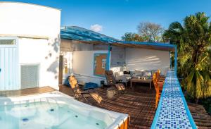 a hot tub on the deck of a house at Air Guest House - con Desayuno & Jacuzzi Social in Medellín