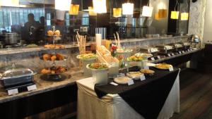 a buffet line with many different types of food at Maya Hotel in Chandīgarh