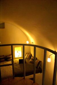 a bedroom with a bed with two lamps on it at Celestia Traditional Houses in Keramoto