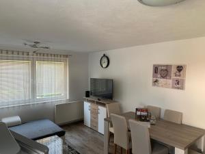 a living room with a table and a dining room at Nexi s Appartement an der Enns 9 in Radstadt