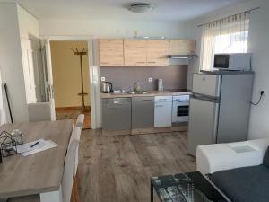 a kitchen and dining room with a table and a refrigerator at Nexi s Appartement an der Enns 9 in Radstadt
