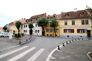 an empty street in a town with buildings at Anne's House in Sibiu +14 photos