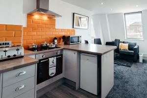 a kitchen with a stove and a counter top at Halifax House, One Bedroom 203 in Halifax