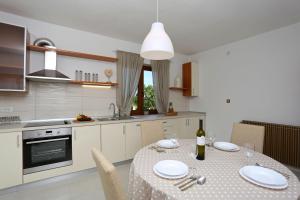 a kitchen with a table with a bottle of wine at House Pauline in Labin +9 photos
