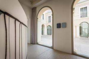 un corridoio vuoto con una grande finestra in un edificio di PALAZZO BECCAGUTTI CAVRIANI - Gallery Suite e Frescoes Suite a Mantova