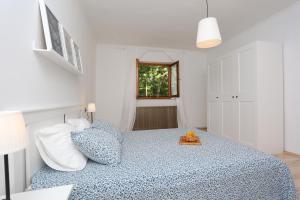 a bedroom with a blue bed with a tray on it at House Pauline in Labin