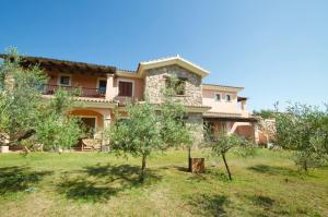 a large house with trees in front of it at Le Dimore di Nettuno - Happy Rentals in Olbia
