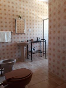 a bathroom with a toilet and a sink at Casa Vermelha in Ouro Preto