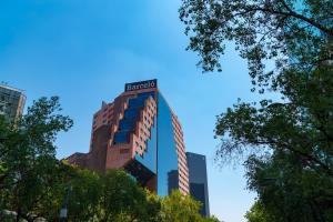 a building with a sign on top of it at Barceló Mexico Reforma in Mexico City