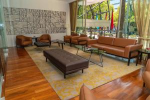 a living room with couches and a couch and tables at Barceló Mexico Reforma in Mexico City