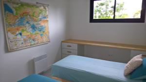 a bedroom with a bed and a map on the wall at Villa piscine Sud France in Verzeille +45 photos