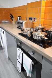 a kitchen with a stove with pots and pans on it at Halifax House, Studio Apartment 209 in Halifax