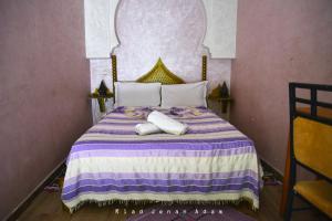 A bed or beds in a room at Riad Jenan Adam