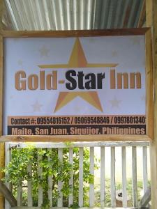 a sign for a gold star inn on a fence at Gold Star Inn in Siquijor
