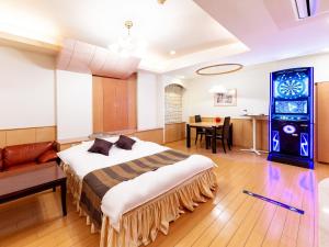a hotel room with a bed and a dining room at Hotel Mine (Love Hotel) in Kurume