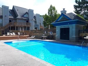 - une piscine en face d'une maison dans l'établissement Condo 211 At North Creek Resort, à Blue Mountains